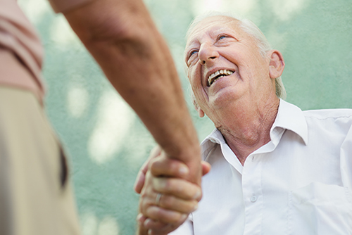 Elderly man shaking hands with doctor