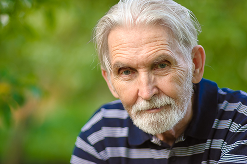 Elderly man wearing blue and white striped shirt
